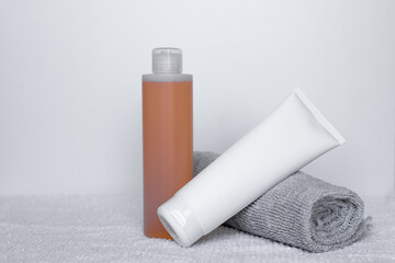 Sleek bathroom essentials with shampoo and body lotion on soft towels in a tranquil setting
