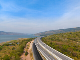 The M6  motorway Expressway Nakhon Ratchasima Province - Bang Pa-in. Lam Ta Khong River and Mountain. Drone shot of scenic landscape rural place traffic. Nakhon Ratchasima Thailand. Motorway Korat