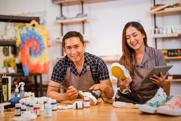 asian in apron staff working at shoes painting studio