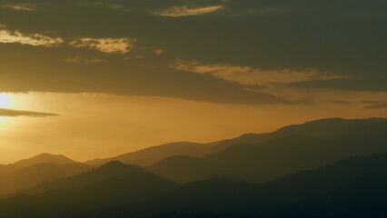 Fototapeta premium Fantastic Warm Sunrise And Over The Mountain. Range Of Mountain And Sunrise. Real time.