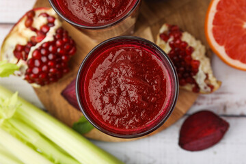 Fresh beetroot smoothie on white table, flat lay