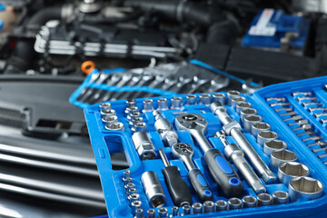 Set of different auto mechanic's tools at automobile repair shop, closeup
