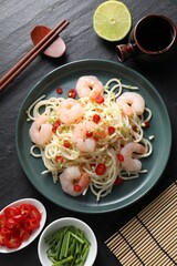 Delicious pasta with shrimps served on black table, top view