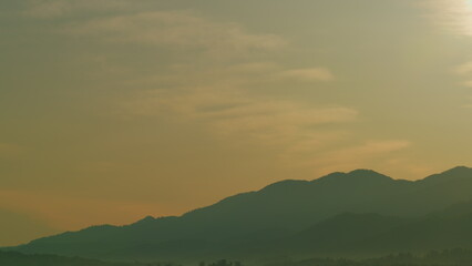 Obraz premium Beautiful Golden Sunrise. Silhouette Of The Mountain Hills Against Sunrise Sky. Real time.