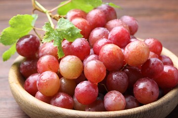 Fresh ripe grapes on wooden table, closeup