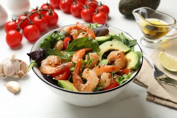 Delicious shrimp salad and ingredients on white table, closeup