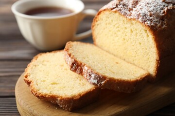 Freshly baked sponge cake on wooden table, closeup