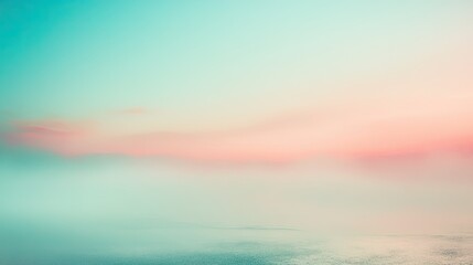 Obraz premium A serene landscape featuring soft pastel colors blending into a misty horizon over water.