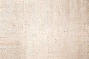 Fototapeta premium A pale pink wallpaper with a floral design in gold