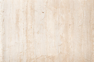 A pale pink wallpaper with a floral design in gold