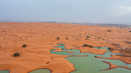 Moroccan Sahara Desert, ancient black volcanic mountains, the Sahara River Oued Ghris, stunning...