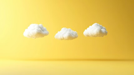 Three fluffy clouds floating against a bright yellow background.
