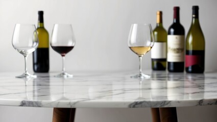 Elegant wine setup featuring red and white bottles with glasses on a marble table, perfect for celebrations, gatherings, and upscale events