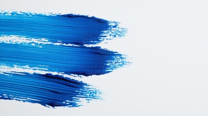 Blue watercolor brush strokes on a white backdrop, showcasing a textured, horizontal design, perfect for creative projects, backgrounds, or artistic expressions.