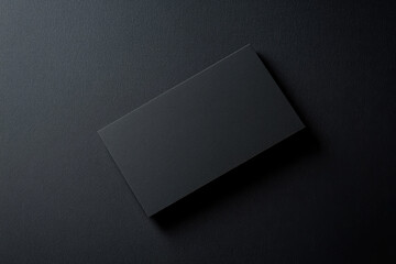 Black business card mockup, top view on a dark background. Created with Ai