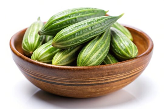 Green pointed gourd or parwal in a bowl isolated on white background