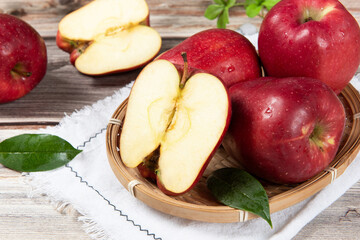 Fresh red delicious apple  cut in half on wooden table.