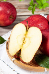 Fresh red delicious apple  cut in half on wooden table.