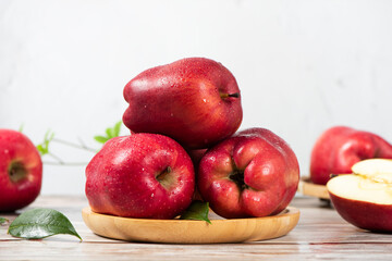 Fresh red delicious apple on wooden table.