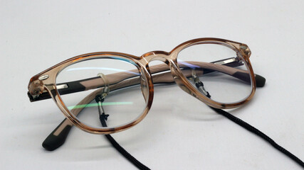 Brown glasses with black eyeglass strap