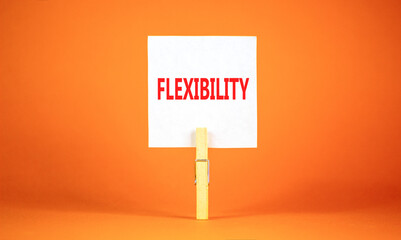 Flexibility symbol. Concept word Flexibility on beautiful white paper on clothespin. Beautiful orange background. Business flexibility concept. Copy space.