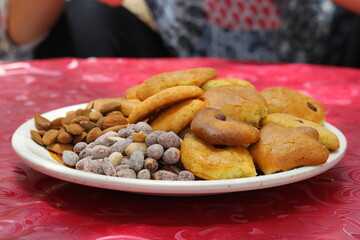 Delicious assorted Moroccan pastries and nuts served on a plate at Paradise Valley in Morocco during a warm day