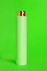 Perfume on green background