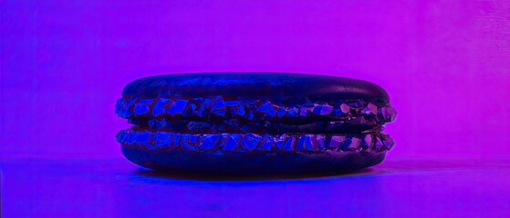 Obraz premium Black Macaron on Purple Background