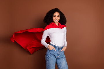 Portrait of nice young girl superhero costume empty space isolated on brown color background