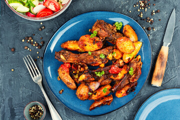 Grilled meat ribs with fried potato.