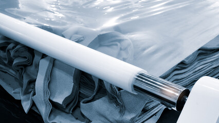 clothing manufacturing workshop, fabric cutting according to template with polyethylene packaging,...