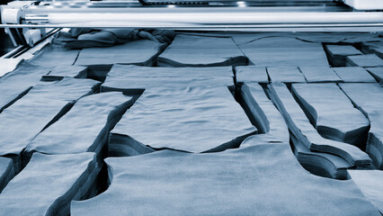 clothing manufacturing workshop, fabric cutting according to template with polyethylene packaging,...