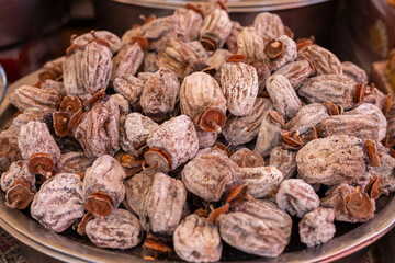 Dried fruit snacks displayed in a traditional market during a vibrant daytime setting