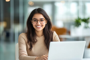 Fototapeta premium young indian woman using laptop at office