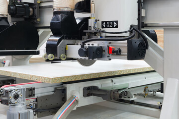 Woodworking factory with big machine for cutting chipboard wood boards, machines and machinery for the production of furniture and wooden products