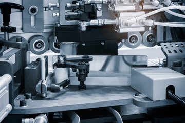 Wood boards on a woodworking machine in a modern furniture factory, woodworking industrial concept background, machine is cutting wood into pieces