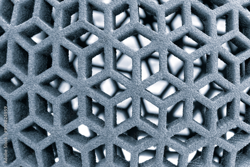 Fototapete A close up of a grey object with a lot of holes. The object is made of a material that is not very dense, and it has a lot of texture. The holes are scattered throughout the object