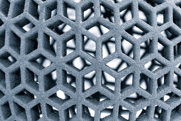 A close up of a grey object with a lot of holes. The object is made of a material that is not very dense, and it has a lot of texture. The holes are scattered throughout the object
