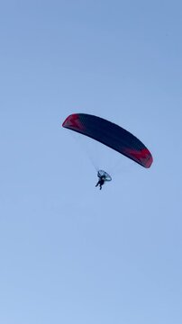 Paraglider gliding in the blue sky. Adventure vacation