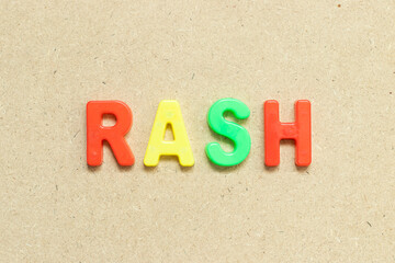 Color alphabet letter with word rash on wood background