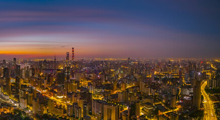 Aerial view of modern city skyline and buildings at sunrise in Shanghai