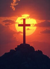 Silhouette of a cross on top of a mountain at sunset.