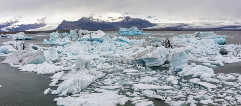many iceberg drifting towards the ocean on a stormy day at J&ouml;kuls&aacute;rl&oacute;n Galcier Lagoon, Iceland
