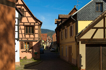 Scenic view of medieval street in in Riquewihr village, France. Typical architecture of Alsace...