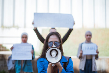 A passionate activist voices her important message with a megaphone at a significant protest