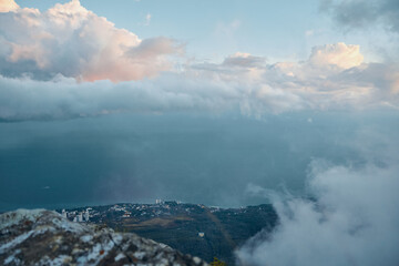 Serene Ocean View from a Majestic Mountain Summit with Fluffy Clouds in the Sky