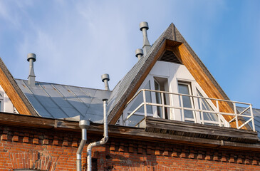 A house with a slanted roof and a balcony