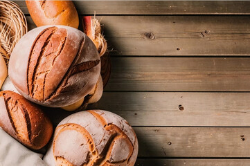 A rustic loaf of sourdough bread with a golden crust, sliced on an old wooden board	
