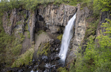 waterfall plunges over a basalt cliff, Magnúsarfoss, Skaftafell Nature Reserve, South Iceland