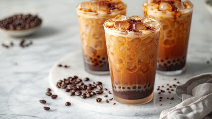 Iced tapioca coffee latte or boba pearl bubbles milk tea, asian trendy cold coffee drink with tapioca balls and crushed ice, on white marble background copy space 